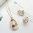 Clear jewellery set with rose gold finish